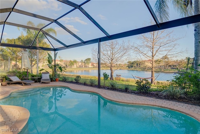 pool with a water view, a lanai, and a patio