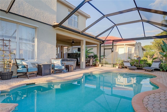 outdoor pool featuring ceiling fan, a patio, and a lanai