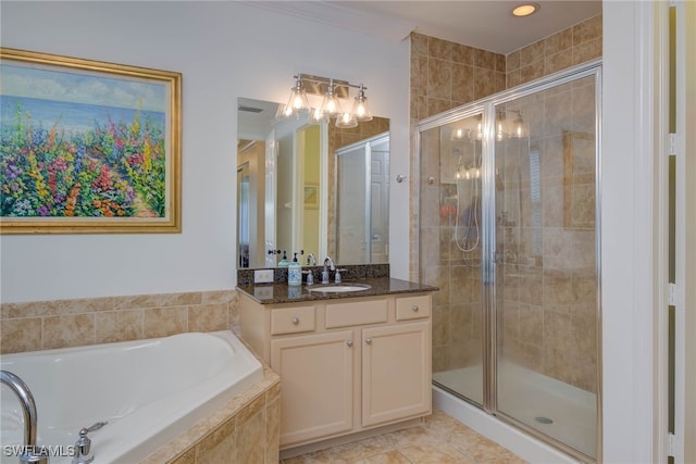 bathroom featuring a bath, a stall shower, tile patterned flooring, and vanity