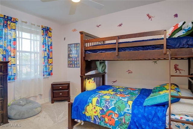 bedroom with ceiling fan, baseboards, and carpet flooring