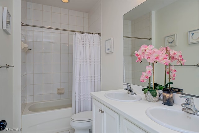 bathroom with double vanity, a sink, toilet, and shower / tub combo with curtain