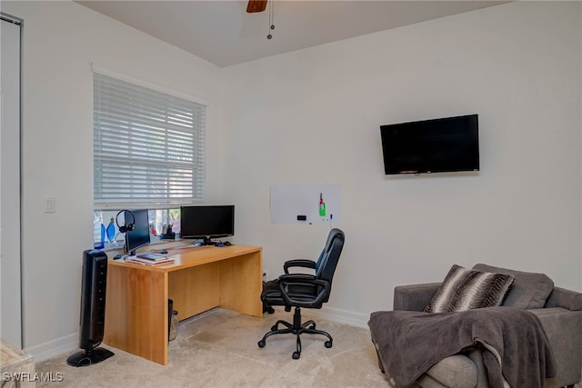 home office featuring ceiling fan, baseboards, and light colored carpet