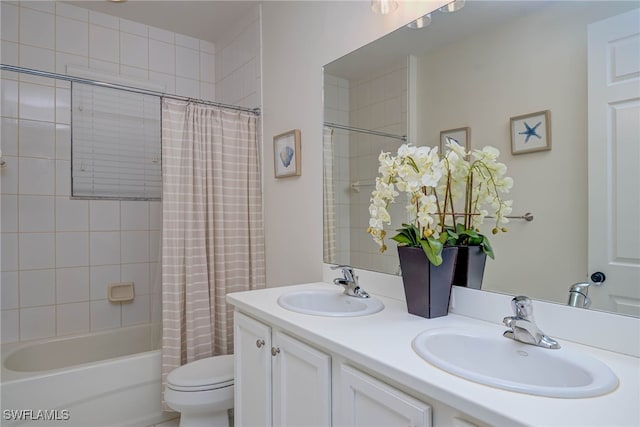 full bath featuring toilet, double vanity, shower / bath combo with shower curtain, and a sink