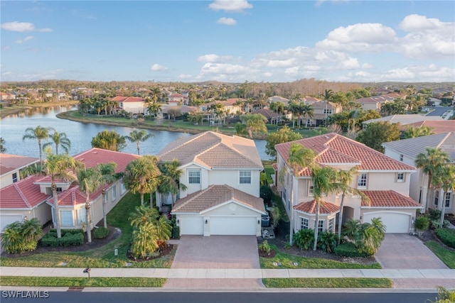 drone / aerial view with a residential view and a water view