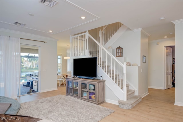 living room featuring stairs, recessed lighting, light wood-style flooring, and crown molding