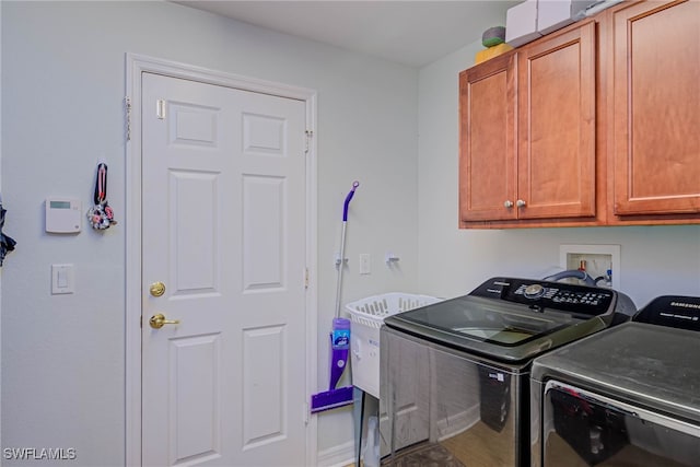 clothes washing area with cabinet space and separate washer and dryer