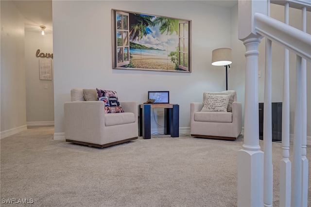 living area featuring stairway, carpet, and baseboards