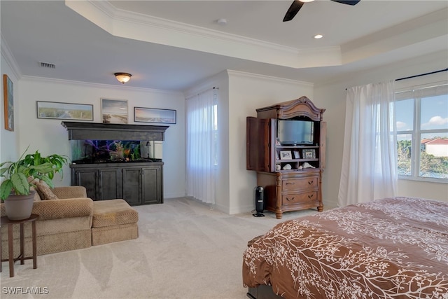 bedroom featuring light carpet, multiple windows, a raised ceiling, and crown molding