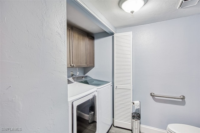 washroom with cabinets and independent washer and dryer