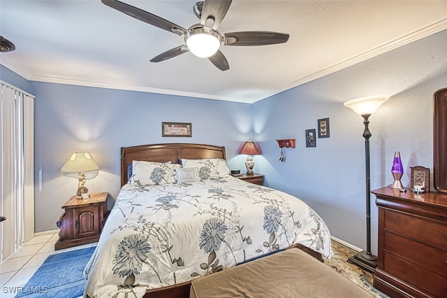 tiled bedroom with ornamental molding and ceiling fan