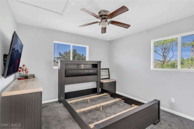 bedroom with ceiling fan and dark carpet