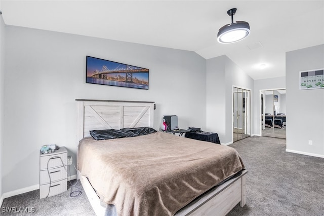 carpeted bedroom featuring lofted ceiling and a closet