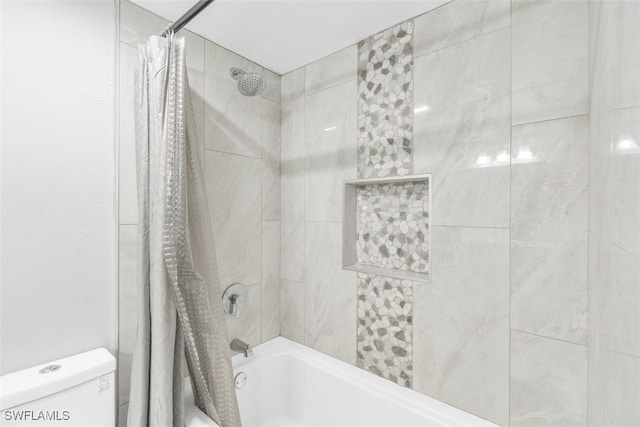 bathroom with shower / tub combo with curtain and toilet