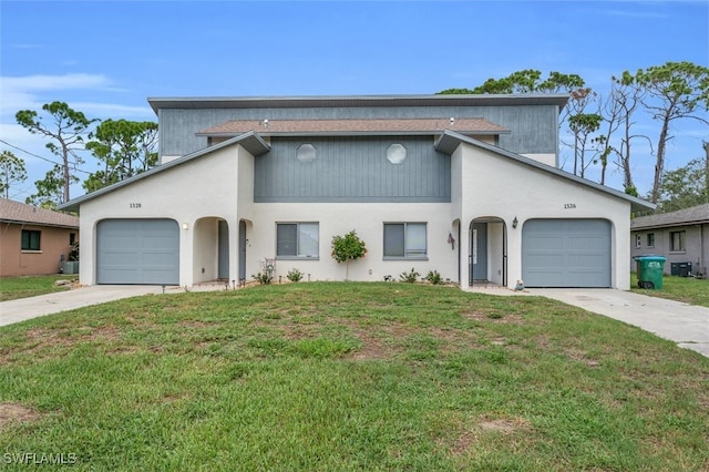 view of front facade featuring a garage and a front lawn