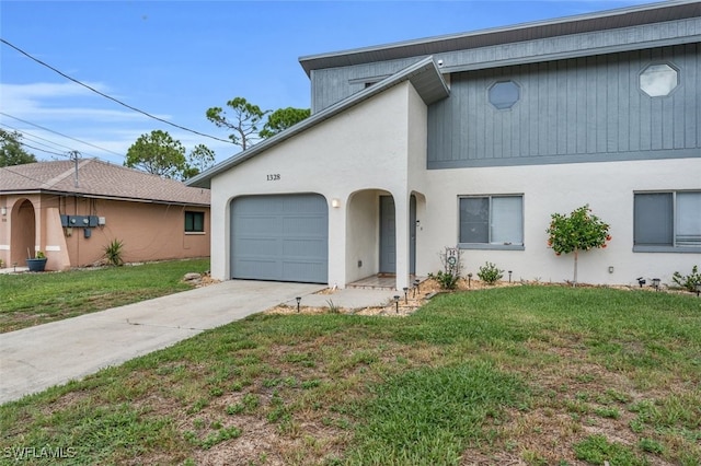 view of front of house featuring a garage and a front lawn