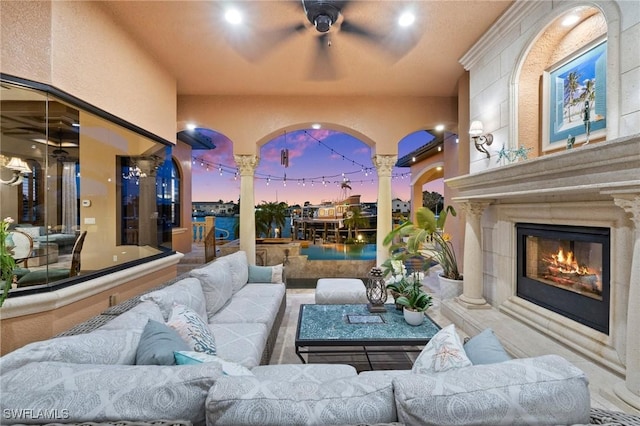 patio terrace at dusk featuring an outdoor living space with a fireplace