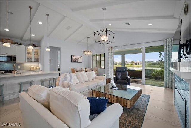 living room with vaulted ceiling with beams, visible vents, a notable chandelier, and recessed lighting