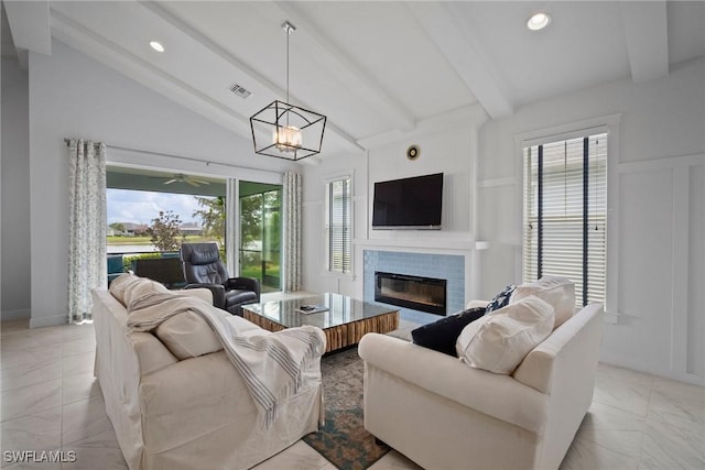 living room featuring recessed lighting, visible vents, a decorative wall, lofted ceiling with beams, and a glass covered fireplace