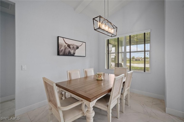 dining area featuring a notable chandelier, marble finish floor, vaulted ceiling with beams, and baseboards