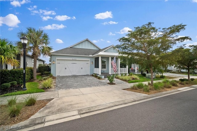 view of front facade featuring decorative driveway and an attached garage