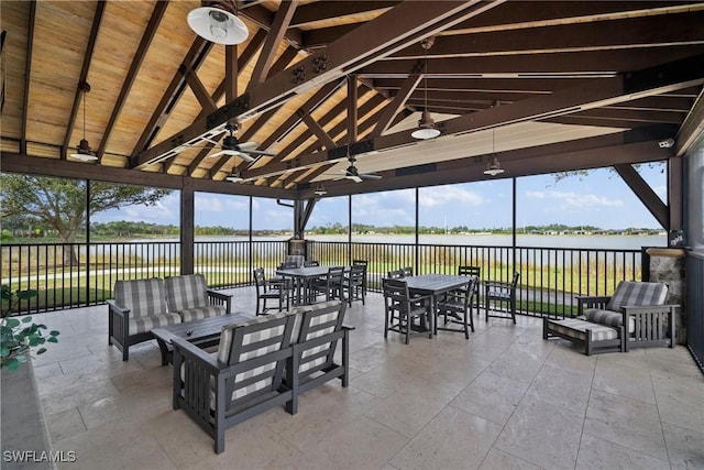 view of patio / terrace with a water view, a gazebo, an outdoor hangout area, outdoor dining space, and ceiling fan