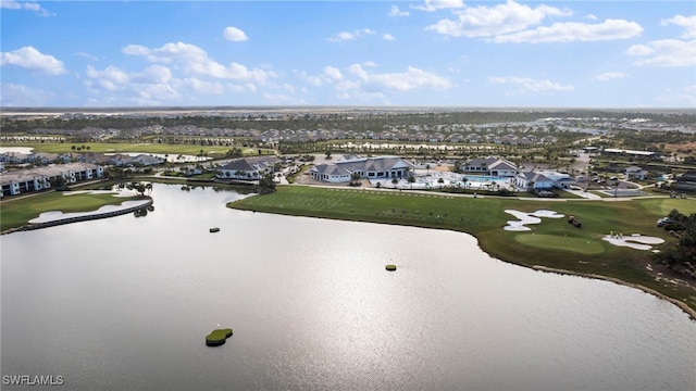 drone / aerial view featuring a water view, view of golf course, and a residential view