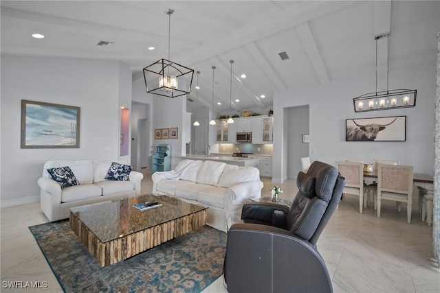 living room with beamed ceiling, an inviting chandelier, visible vents, and baseboards