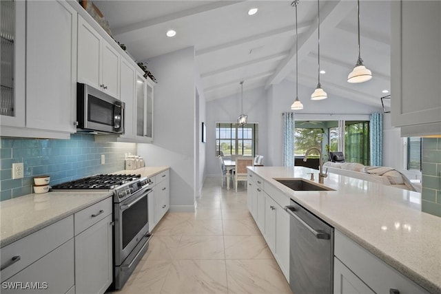 kitchen featuring stainless steel appliances, hanging light fixtures, glass insert cabinets, and white cabinets