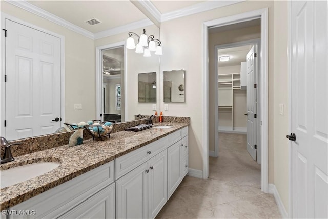 bathroom with tile patterned flooring, crown molding, vanity, and a chandelier