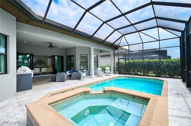 view of pool featuring a patio area, an in ground hot tub, a lanai, ceiling fan, and an outdoor living space