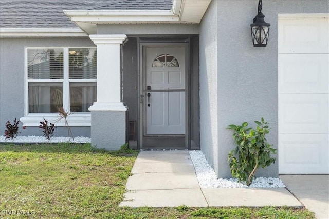 doorway to property with a yard