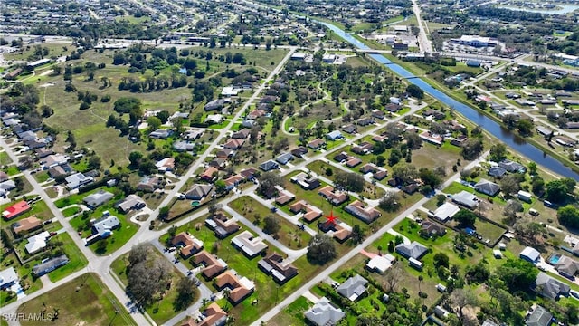 drone / aerial view with a water view and a residential view