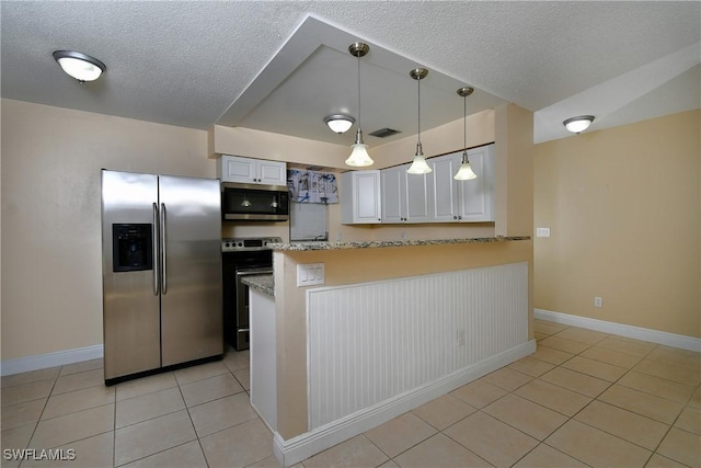 kitchen with light tile patterned floors, visible vents, white cabinets, stainless steel appliances, and pendant lighting