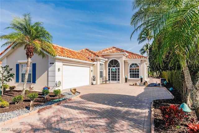 mediterranean / spanish-style home featuring a garage