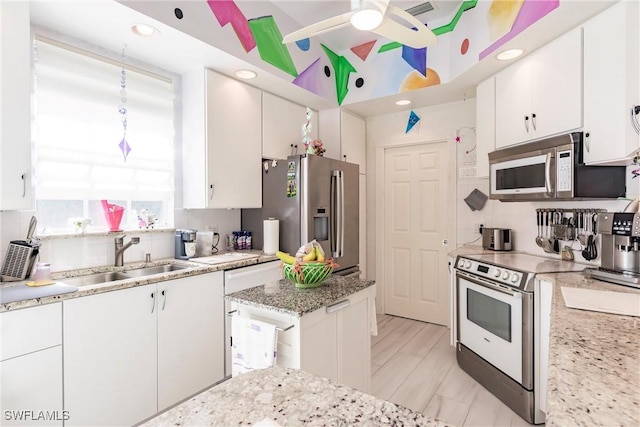 3500 Donoso Ct, Naples, FL 34109 - kitchen with white microwave, a sink, electric range oven, stainless steel refrigerator with ice dispenser, and backsplash
