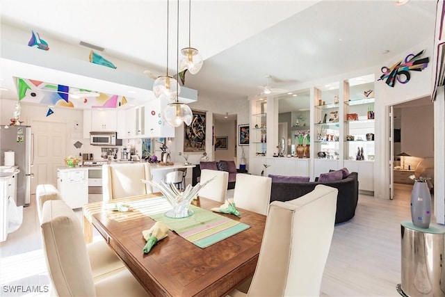 dining area featuring light hardwood / wood-style flooring and ceiling fan