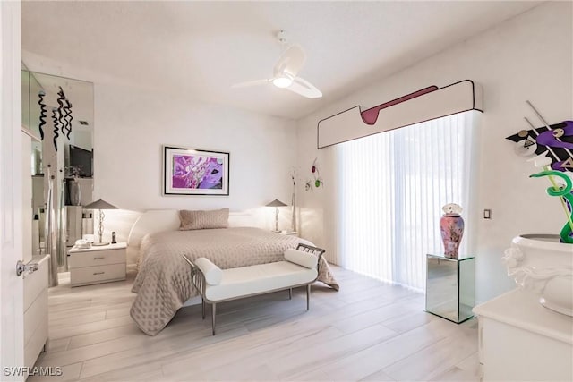 bedroom with light hardwood / wood-style flooring and ceiling fan