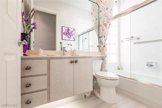 full bathroom with toilet, vanity, and enclosed tub / shower combo