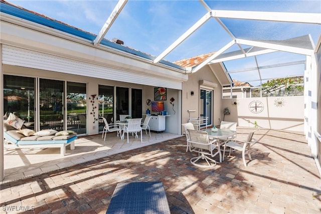 view of patio with glass enclosure