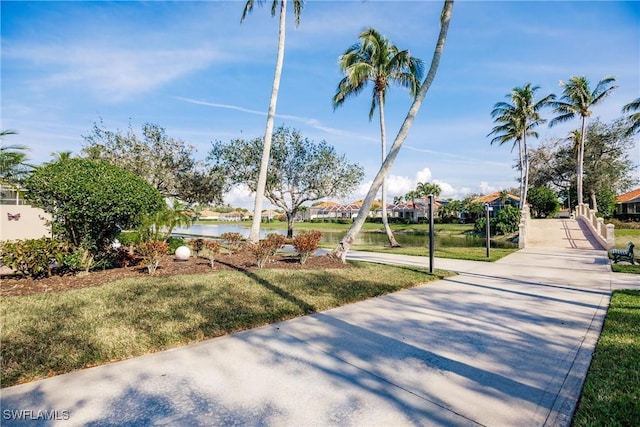 view of community featuring a yard and a water view