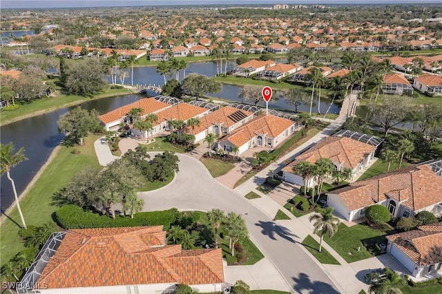 birds eye view of property with a water view and a residential view