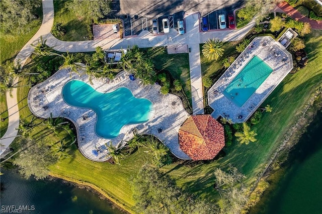 birds eye view of property with a water view