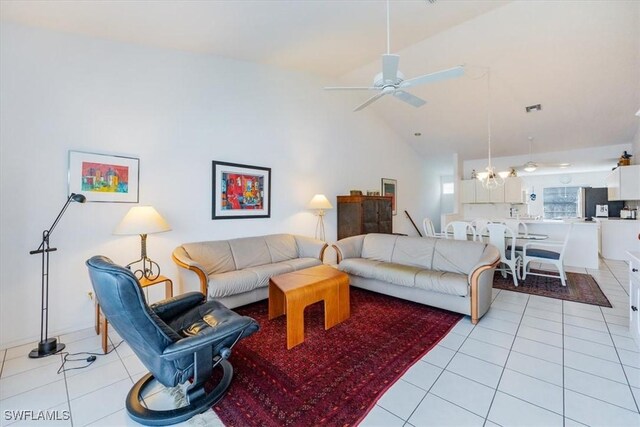 1090 Partridge Cir Unit 201, Naples, FL 34104 - tiled living room featuring ceiling fan with notable chandelier and high vaulted ceiling