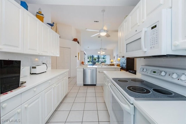 1090 Partridge Cir Unit 201, Naples, FL 34104 - kitchen with white appliances, light tile patterned floors, white cabinets, and decorative backsplash