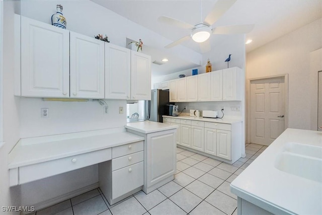 1090 Partridge Cir Unit 201, Naples, FL 34104 - kitchen with stainless steel fridge, sink, ceiling fan, white cabinets, and light tile patterned flooring