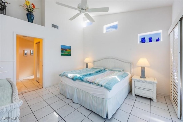 1090 Partridge Cir Unit 201, Naples, FL 34104 - tiled bedroom with ceiling fan and high vaulted ceiling