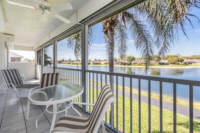 1090 Partridge Cir Unit 201, Naples, FL 34104 - sunroom featuring ceiling fan and a water view