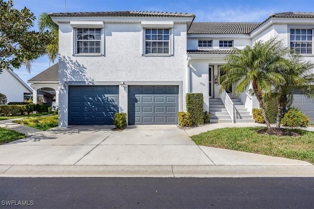 1090 Partridge Cir Unit 201, Naples, FL 34104 - mediterranean / spanish home featuring a garage