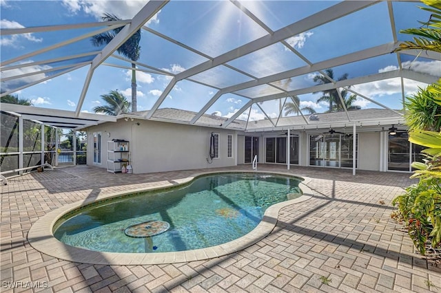 pool featuring a patio, a lanai, and a ceiling fan