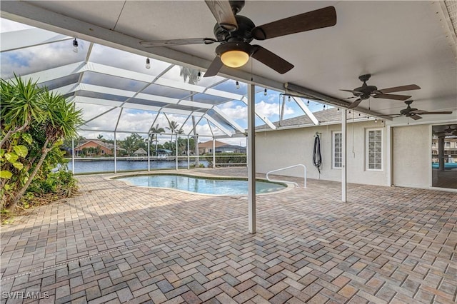 outdoor pool featuring ceiling fan, a patio, and glass enclosure